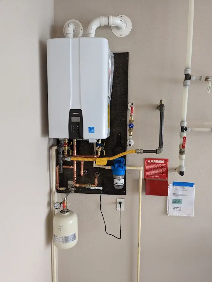 Professional plumber installing copper piping in a Denmark home